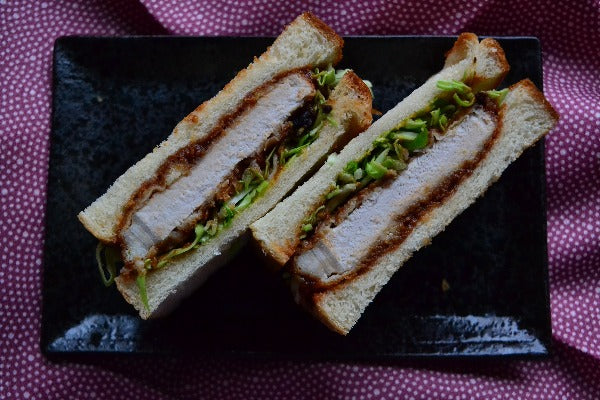 Katsu sando on a black serving plate