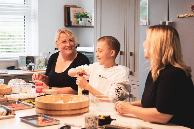 A family enjoying a sushi making lesson