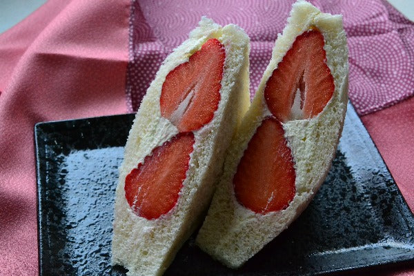 Fruit sando on a black serving plate