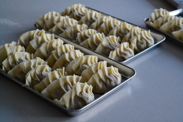 Two trays of gyoza hand crafted